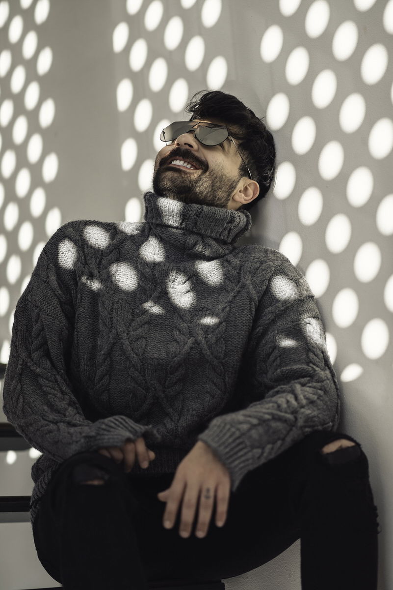 Model in a wool coat photographed against a Karaköy storefront for a fashion lookbook